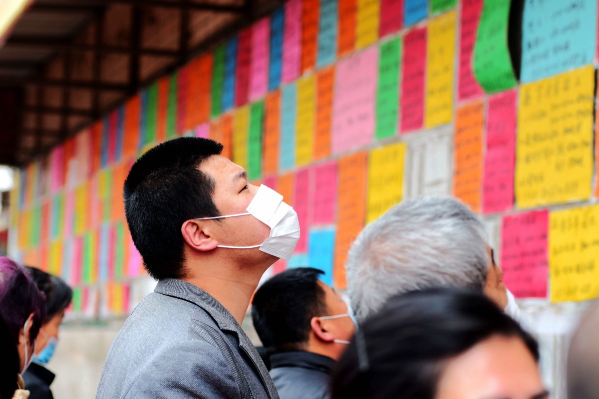 A man looks for employment opportunities in a job market in Qingdao in east China's Shandong province Wednesday, April 08, 2020. | The Wire