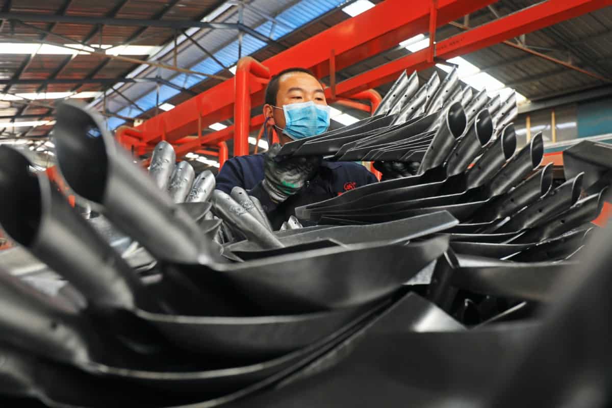 Workers busy in the production line of steel spade polishing in Hebei Province, China.